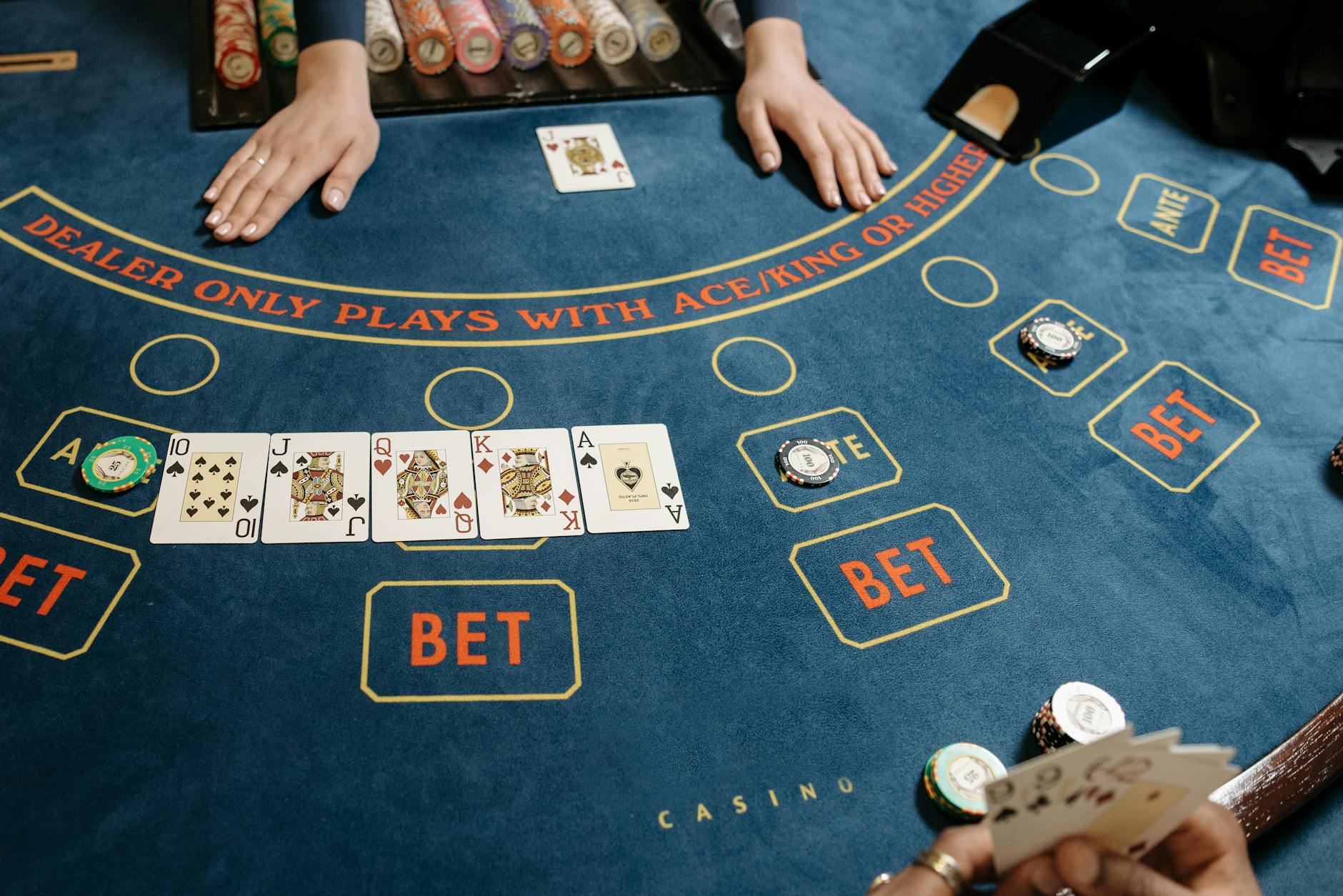 cards and casino tokens on baccarat table