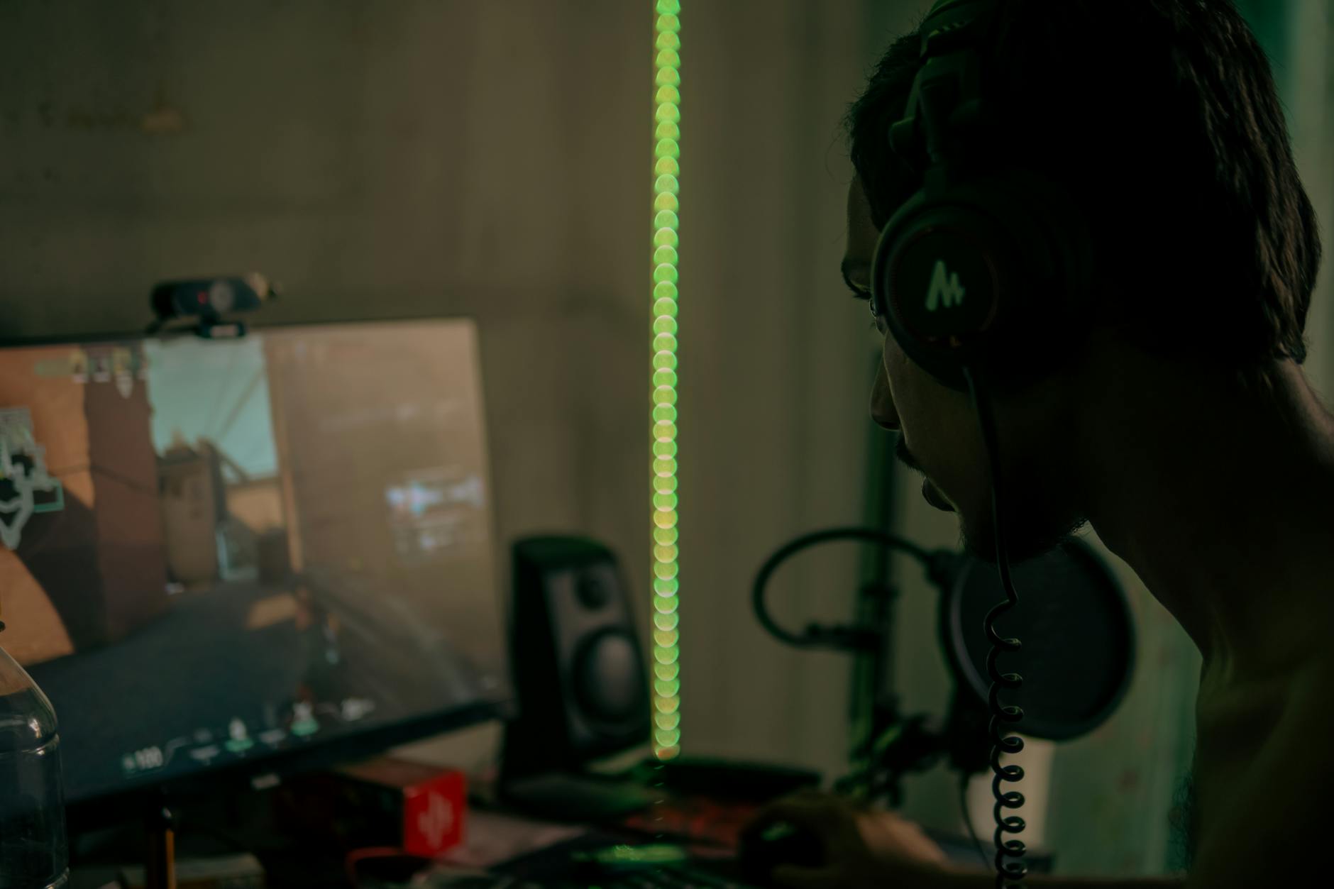 man with headset playing computer game
