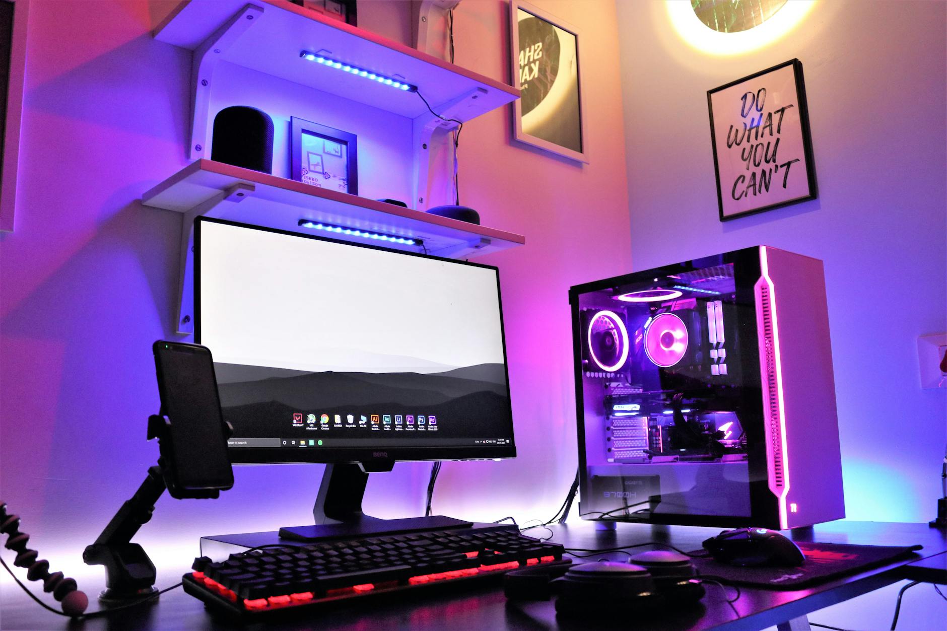 computer with headphones and a smartphone on the desk
